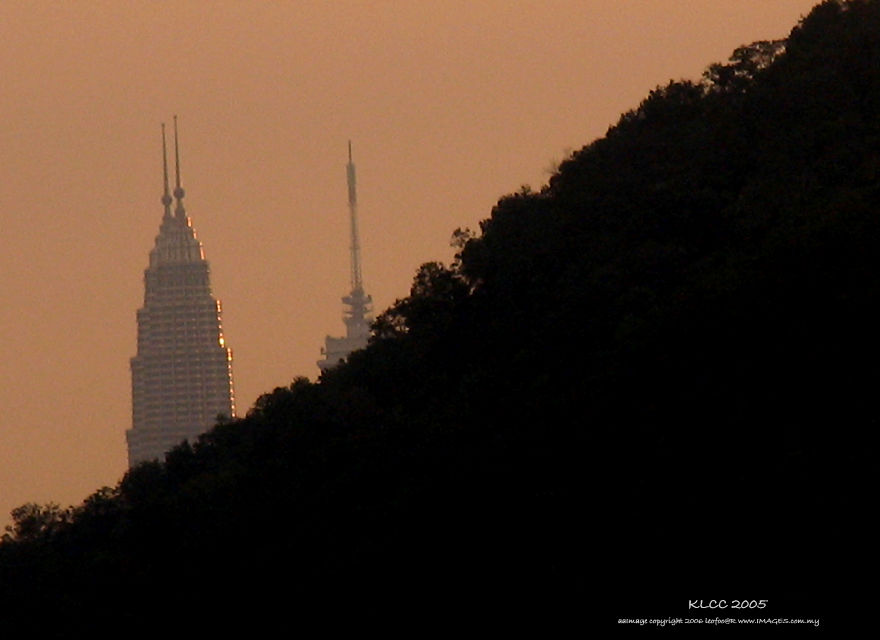 Petronas Twin Towers KLCC and KL Towers behind the hills