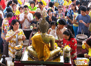 Thai Public performing their pilgrimage to the Buddha during Songkran festival at Wat Suthat, 2007