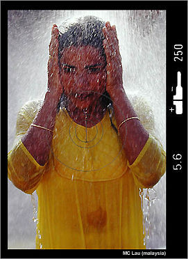 A devotee clensing her body during Thaipusam festival