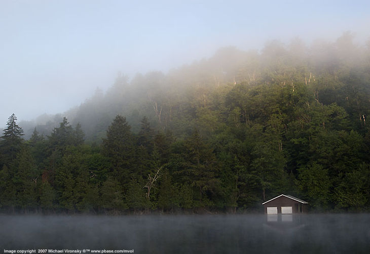 Misty dawn at lake front by Michael Volinsky