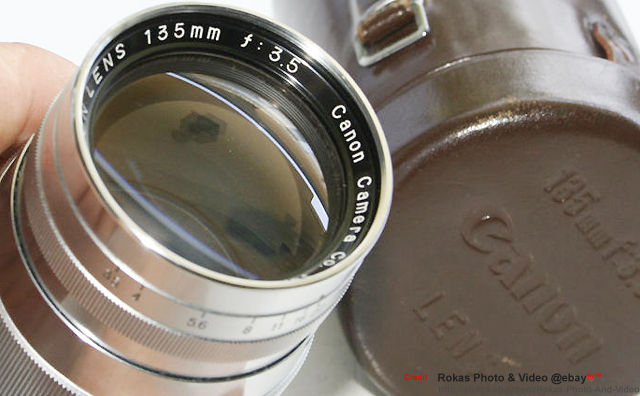 all chrome Canon 135mm f/3.5 telephoto lens with leather lens case