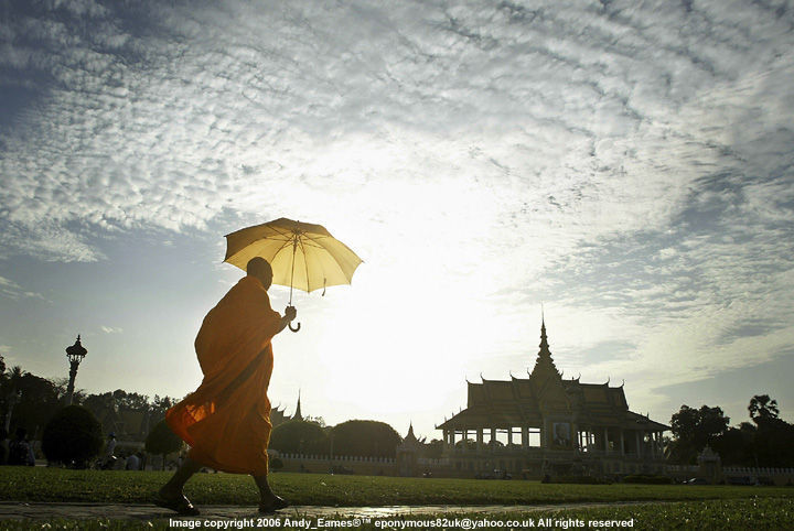 A Buddhist Monk passing by the opened space in front of the Royal Palace in Phnom Penh, Cambodia