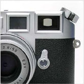 Viewfinder/rangefinder with additional 0.85x magnification